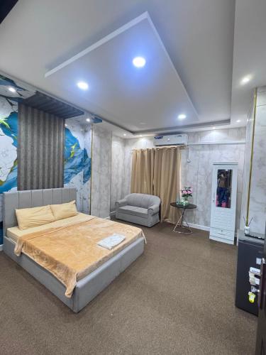 a bedroom with a large bed and a couch at Royal International in Abu Dhabi