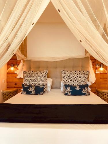 a bedroom with a bed in a tent at Hôtel Hamaha Beach in Mamoudzou