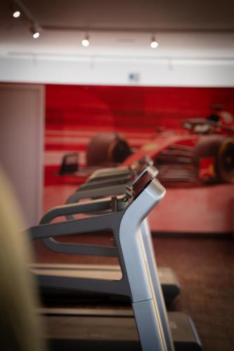 a row of seats in a gym with a red wall at Maranello Palace in Maranello