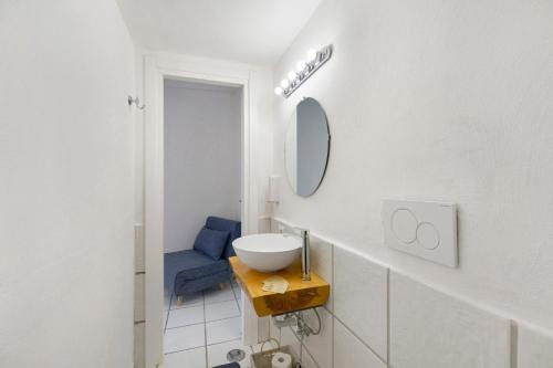 a white bathroom with a sink and a mirror at Casa Vacanza Sunshine in Meta