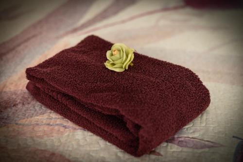 a red towel with a yellow flower on it at Barnhouse Duplex in Idanha-a-Nova