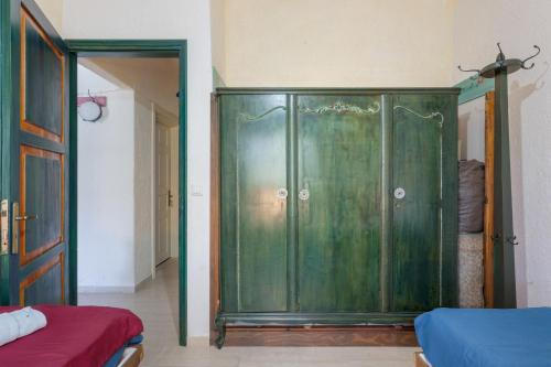 a green cabinet in a room with a bed at Elia Cottage in Sitia