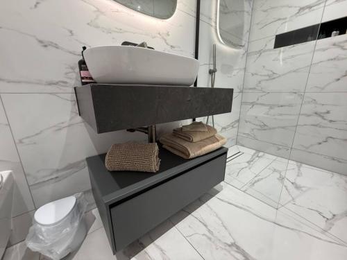 a white bathroom with a sink and a shower at Auberge Hotel by Sasco in Lytham St Annes