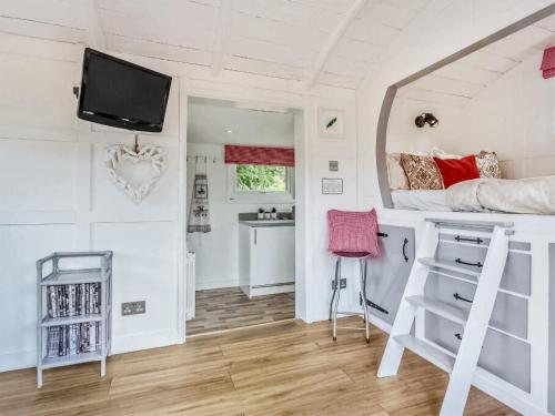 a bedroom with a bunk bed and a desk at Lovers Carriage - Uk46404 in Cowbridge