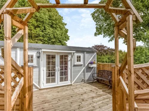 a large white shed with a wooden pergola at Lovers Carriage - Uk46404 in Cowbridge