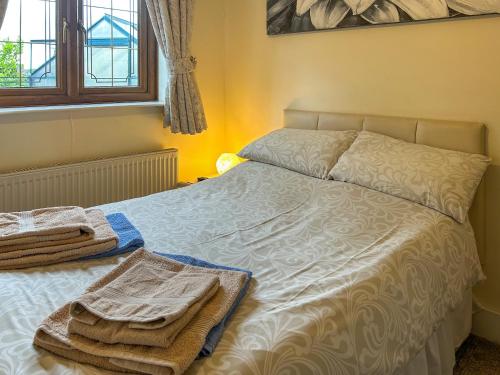 a bed with towels on it in a bedroom at Bramble Grange in Derby