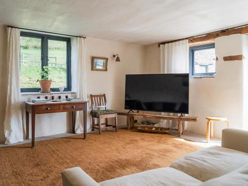 a living room with a large flat screen tv at Blaenau - Uk50400 in Llanstephan