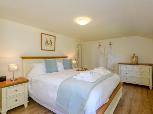 a bedroom with a bed with towels on it at The Chicken Coop in Fulletby