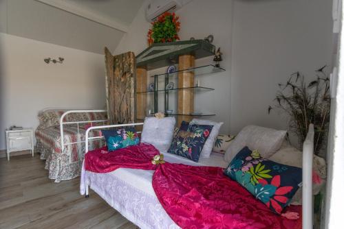 a living room with a bed with a red blanket at Courtyard T0 Studio Farmhouse in Idanha-a-Nova