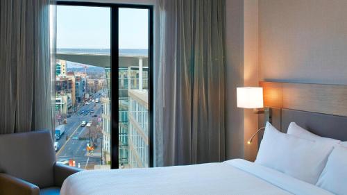 a hotel room with a bed and a large window at AC Hotel by Marriott Minneapolis Downtown in Minneapolis