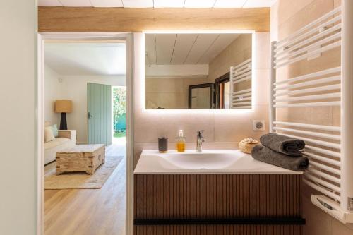 a bathroom with a sink and a mirror at Villa Flore - Panoramic Sea View by Halldis in Vallauris
