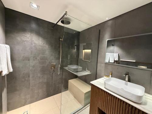 a bathroom with a sink and a shower at Arabian Palace Hotel in Al Rahba
