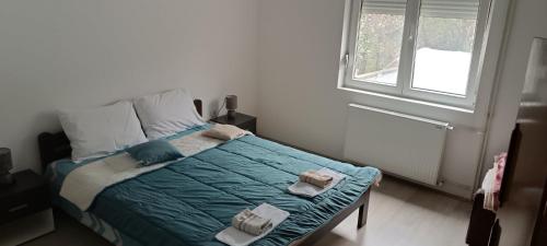 a bedroom with a bed with two towels on it at Apartman Miljkovic in Arandelovac