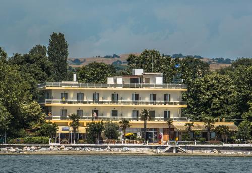 un bâtiment sur la rive d'une masse d'eau dans l'établissement Hotel Achillion, à Makrigialos