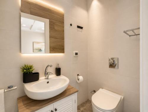 a bathroom with a sink and a toilet at Safra - Hotel rooms in Tel Aviv