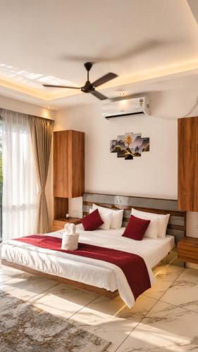 a bedroom with a large bed with red pillows at Beachside Agatti Resort in Agatti