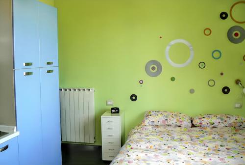 a bedroom with a bed and planets on the wall at Comfortable Studio in Nicolosi, 25 m² in Nicolosi