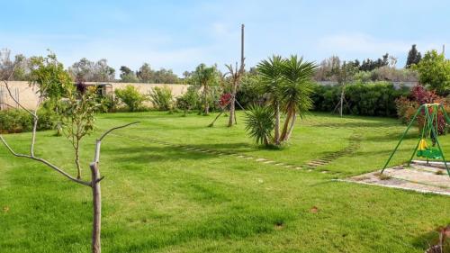 a yard with a playground and a swing at Charming House in Gallipoli + Terrace in Gallipoli