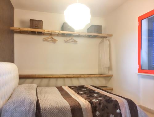a bedroom with a bed and a shelf on the wall at Charming House in Gallipoli + Terrace in Gallipoli