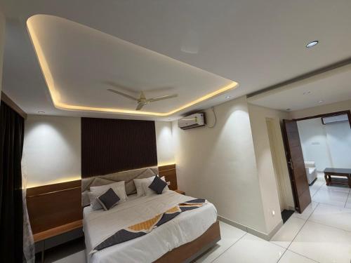 a bedroom with a bed with a ceiling at Senary's Nest INN in Kyātsandra