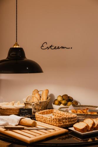 a table topped with lots of bread and baskets of food at Esteem Tour Eiffel in Paris