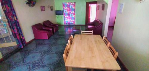 a room with a wooden table and chairs in a room at Family apartment with pool in Trou-aux-Biches, 80 m² in Trou aux Biches