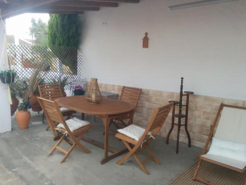 a wooden table and chairs on a patio at Charming House Santarém + Pool in Santarém