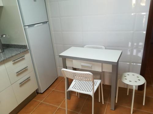 a small kitchen with a table and two chairs at Charming Apartment La Oliva 30 sqm + Terrace in La Oliva