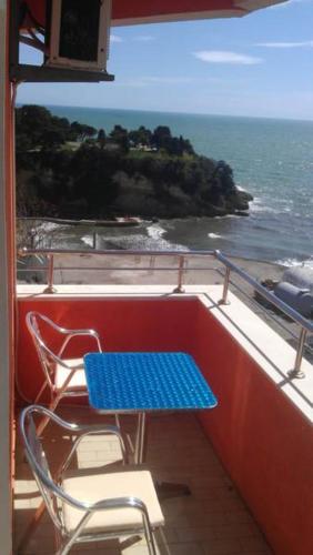 a blue table and chairs on a balcony overlooking the ocean at Sea View Apartment - Ulcinj - 40 sqm in Ulcinj