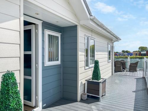 a front porch of a house with a blue wall at Serenity At Lakeside - Uk51947 in Patrington