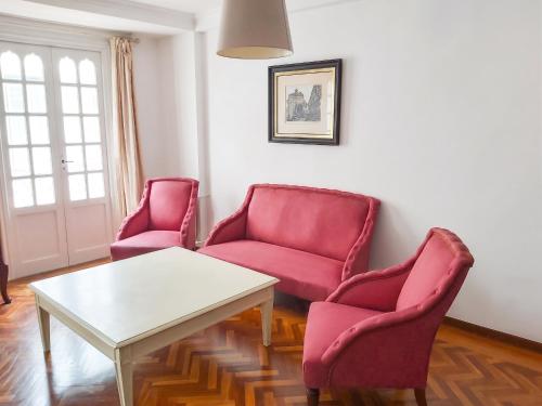 a living room with two chairs and a table at Spacious house with terrace and balcony in A Coruña in A Coruña