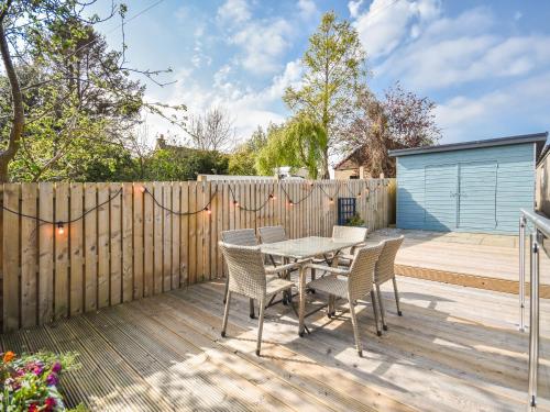 a patio with a table and chairs and a fence at Struan in Kilconquhar