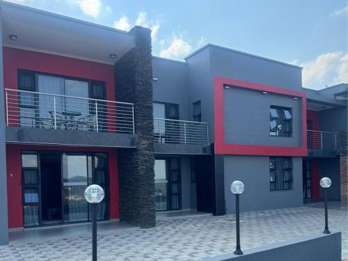a row of houses with red and white at Vista Royale Luxury Villas in Mbabane
