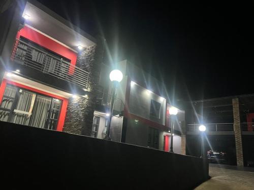a building with two street lights in the dark at Vista Royale Luxury Villas in Mbabane
