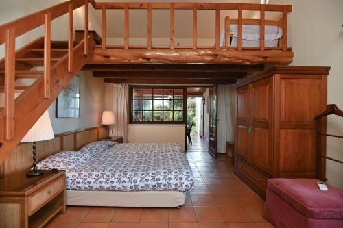 a bedroom with a bunk bed and a staircase at Casa do Moinho in Ulgueira