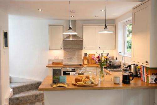 a kitchen with a counter with a plate of food on it at Willow Cottage in Pateley Bridge