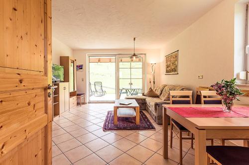 a living room with a couch and a table at Waldlust in Abtsgmünd