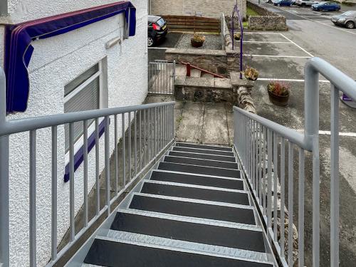 a stairway leading up to a building with a gate at Heathergems Apartment in Pitlochry