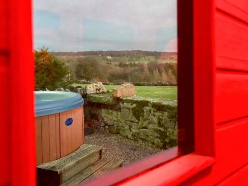 a window with a tub and a stone wall at Henrys Haunt-Rxx8 in Stanton in Peak