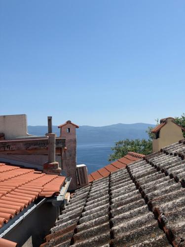 a view of the roofs of a building with the ocean at Villa Darche in Vrbnik