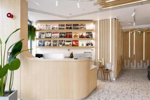 a lobby with a reception counter with a potted plant at Bird Nest Suites in Istanbul