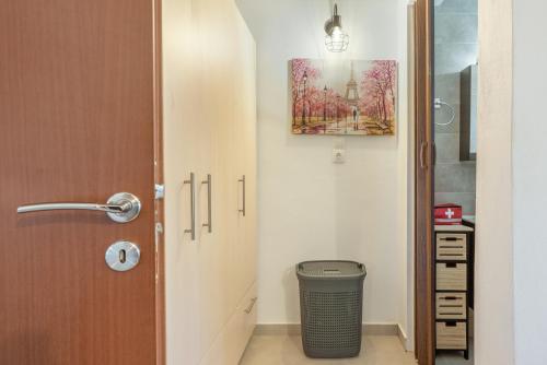a hallway with a door and a trash can in a room at Lydia Guest House in Palekastron