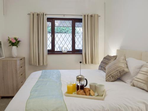 a tray of food on a bed in a bedroom at Sea Breeze in The Mumbles