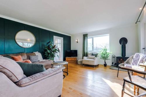 a living room with a couch and a fireplace at Ascot House in Buxton