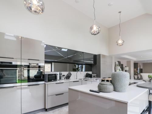 a kitchen with white cabinets and a white counter top at 15 Chivits - Ukc8971 in Warkworth