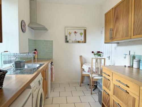 a kitchen with a sink and a counter top at Leaderfoot Cottage in Selkirk