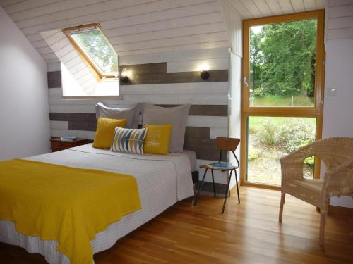 a bedroom with a bed with a yellow blanket at L'écurie in Cohiniac