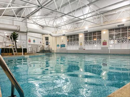 a swimming pool with blue water in a building at 178 Residences - Ukc8998 in Ilfracombe