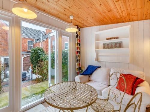 a living room with a couch and a table at Pebble Cottage in Weymouth