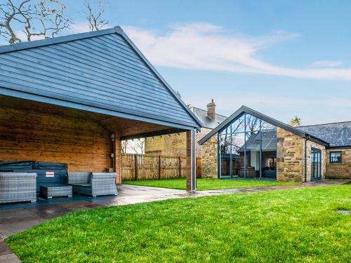 an extension to a brick house with a patio at 13 Shearling - Ukc8974 in Warkworth